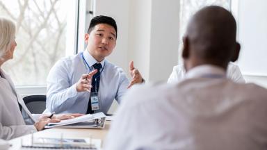 An office worker talking in a meeting.