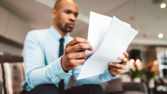 An office worker reading through some notes.